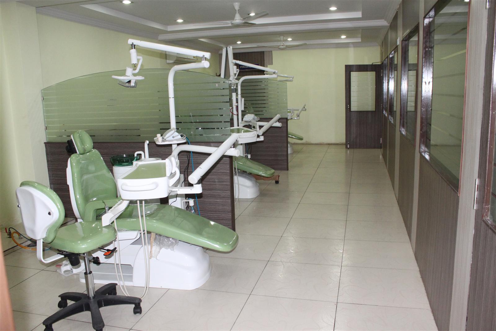 Row of green dental chairs in the treatment area